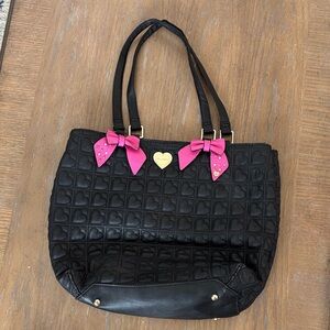 Betsy Johnson black tote bag with quilted heart pattern and pink bows.